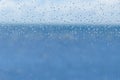 Blur blue water and sky through transparent rainy window Royalty Free Stock Photo