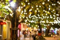 Blur - bokeh - Decorative outdoor string lights hanging on tree in the garden at night time Royalty Free Stock Photo