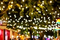 Blur - bokeh - Decorative outdoor string lights hanging on tree in the garden at night time Royalty Free Stock Photo