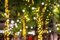 Blur - bokeh - Decorative outdoor string lights hanging on tree in the garden at night time Royalty Free Stock Photo