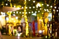 Blur - bokeh - Decorative outdoor string lights hanging on tree in the garden at night time Royalty Free Stock Photo