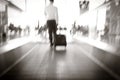 Blur, Businessman dragging a small carry on luggage suitcase