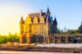 defocused castle in the rays of the rising or setting sun, sun flare and blur Royalty Free Stock Photo