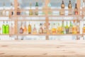 blur cocktail pub restaurant wooden counter bar with alcohol bottles drink mixer full on shelf background for advertising montage Royalty Free Stock Photo