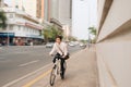 Blur concept. Hurry Asian businessman riding bike in rush hour. Young man late for train work, meeting. Office life and business