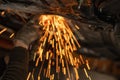 Blur, Cuts off the catalyst on the vehicle, sparks fly. Man repairing of corrugation muffler of exhaust system. Workshop -