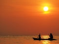 Blur defocus beautiful orange sky sunset above the sea with silhouette of man and boy paddle kayak in sea at Koh Kood, Thailand. Royalty Free Stock Photo