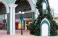 Blur, defocused image of shopping mall for Christmas. Snow in the foreground. Concept of purchase, festive atmosphere