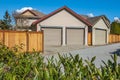 Blur Double garage with short driveway in a sunny day. Garage Door in a perfect neighbourhood