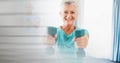 Blur effect with copy space against caucasian senior woman working out with dumbbells Royalty Free Stock Photo