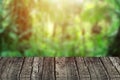 Blur green nature forest with wooden table top forground for advertising background Royalty Free Stock Photo