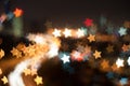 Blur image of Kuala Lumpur city, star bokeh shape with light trail