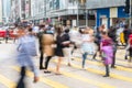 Blur image of pedestrian walking, crossing street busy city