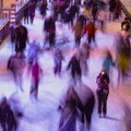 Blur image with people, winter, friendship, sport and leisure concept - skating on rink outdoors