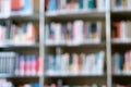 Blur image of shelf with books in library. Background