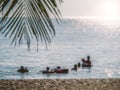 Blur image of silhouettes of happy people swimming on the beach