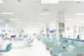 Blur indoor large hospital patient waiting area hygiene hall white clean sitting space for background Royalty Free Stock Photo