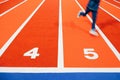 Blur motion of boy is running on indoor athletic child`s running track Royalty Free Stock Photo