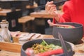 Blur motion of the red shirt women hand hold chopsticks eat noodle Royalty Free Stock Photo