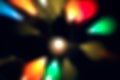 Blur multicolored abstract bokeh background on black background. Defocused abstract multicolored retro or disco light.