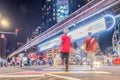 Blur pedestrians crossing busy zebra crossing road at night