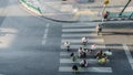 Blur people are moving across the pedestrian crosswalk