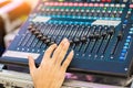 Blur Photo Hand adjusting audio mixer. sound engineer hands working on sound mixer in live concert. Royalty Free Stock Photo
