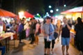 Blur picture of people walk in the street night maket.