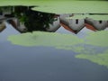 Blur red roof houses reflection in lake