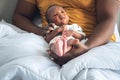 Blur soft images of An African American father holding his 12-day-old baby newborn son