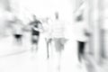 Blur store with bokeh background. Silhouettes of Business People in Blurred Motion Walking. Business people walking in the office Royalty Free Stock Photo