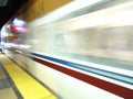 Blur of VTA transit lightrail train arrives into station at night