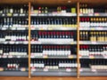 Wine bottles on shelf Supermarket Liquor store Blur background Royalty Free Stock Photo