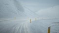 Blur yellow pole in the road full of snow.