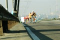 Blured athlets on the city bridge. Marathon running race, people feet on city road. Marathon through the roads of city Royalty Free Stock Photo