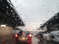 Blured background with rains drop on glass and cars on the road, Road view through car window blurry with rain Royalty Free Stock Photo