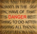 Blured text on vintage paper with focus on DANGER