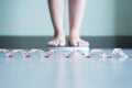 Blured of woman foot standing on weigh scales with tape measure in foreground Royalty Free Stock Photo