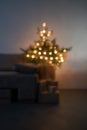 Blurre background of room with illuminating christmas tree in the evening