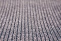 Blurred abstract background of grey knitted fabric made of silvery yarn.