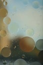 Blurred abstract background. Macro shot of oily liquid. Circles and wavy lines of different sizes light blue, brown and gray. Royalty Free Stock Photo