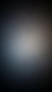 A blurred abstract background with a soft gradient of dark gray blue and light gray tones creating a subtle and atmospheric visual Royalty Free Stock Photo