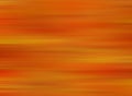 Blurred and abstract fall background. Colorful red and orange linear autumn colored.