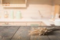 Blurred and abstract kitchen background. Wooden tabletop with wheat and defocused modern kitchen for display your products. Royalty Free Stock Photo