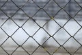 Blurred abstract landscape grid fence. Metal grid texture background. Royalty Free Stock Photo