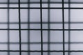 Blurred  Abstract Minimal style black and whith rays of sunlight cast shadows on the wire mesh steel metal Royalty Free Stock Photo