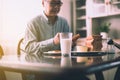 Blurred of asian elderly man preparing healthy food for breakfast with bread and butter,Retirement senior lifestyle living conc