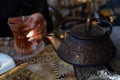 Blurred Azerbaijani woman drinking traditional tea with metal teapot Royalty Free Stock Photo