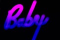 Blurred Baby word in proton purple neon color on black background