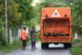 blurred background back view garbage truck filled with garbage bag while service at street in the alley